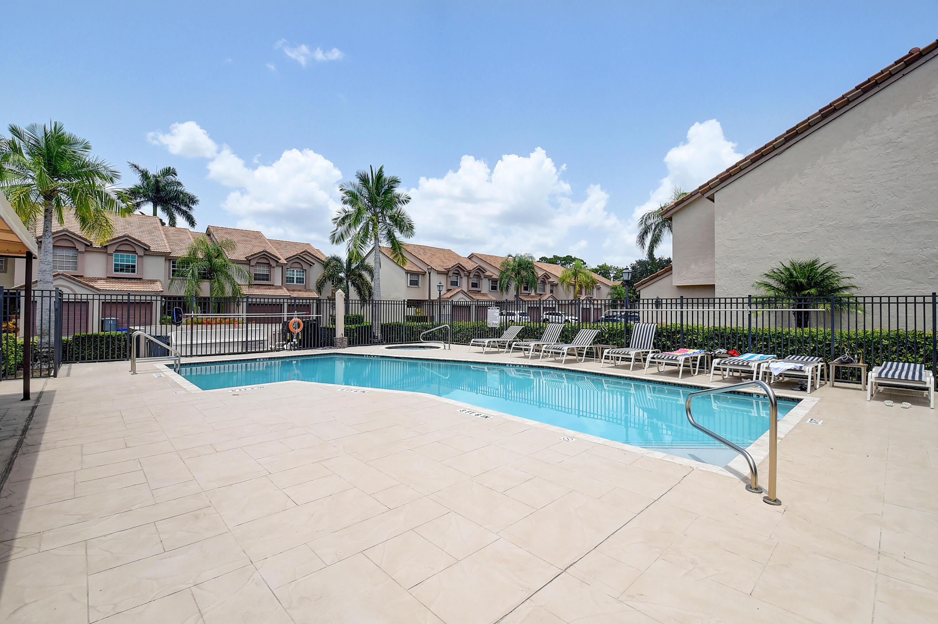 9518 Boca River Circle Boca Raton, FL 33434 - Photo 31 of 34 a view of a swimming pool with a lounge chair