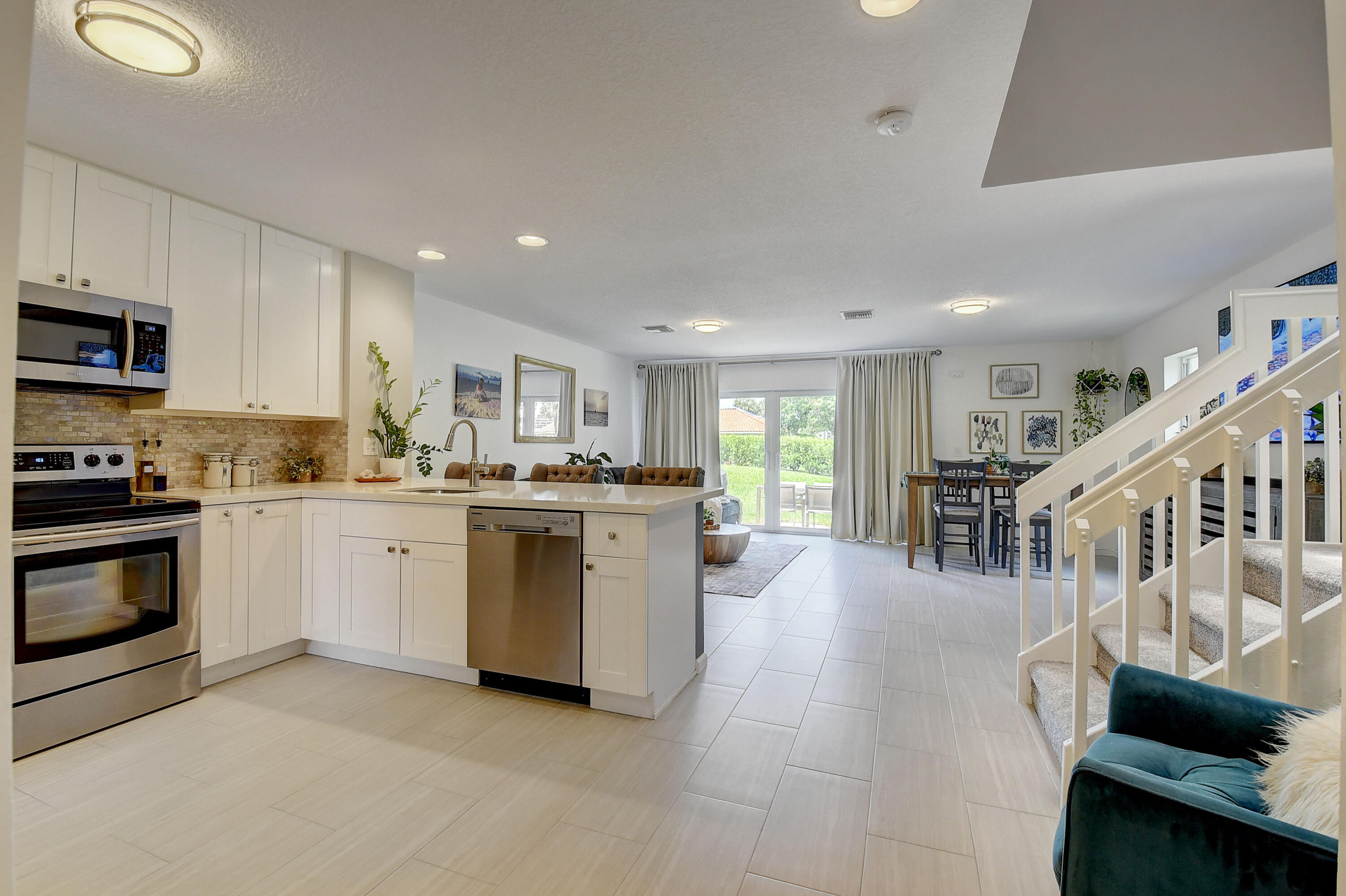 9518 Boca River Circle Boca Raton, FL 33434 - Photo 6 of 34 a kitchen with white cabinets and white appliances