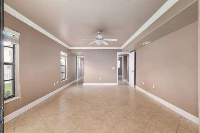 a view of an empty room with windows and cabinet