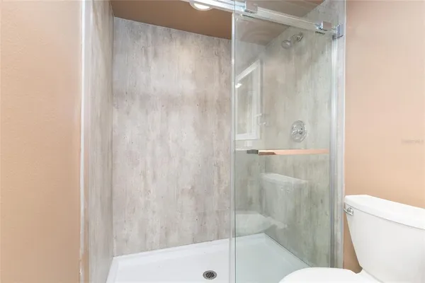 a bathroom with a shower and a toilet