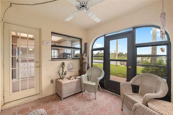 a living room with furniture and a floor to ceiling window