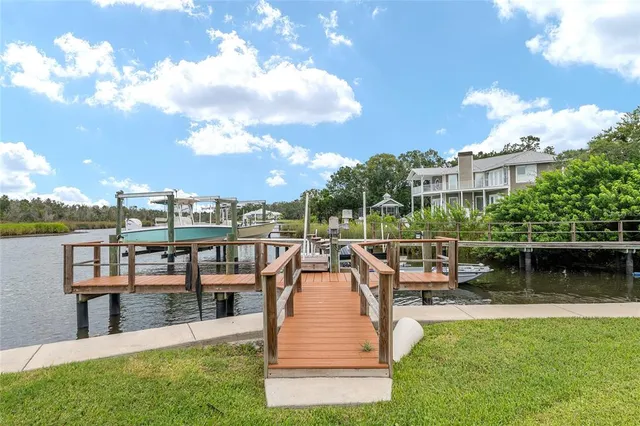 a view of a balcony with wooden floor and outdoor seating