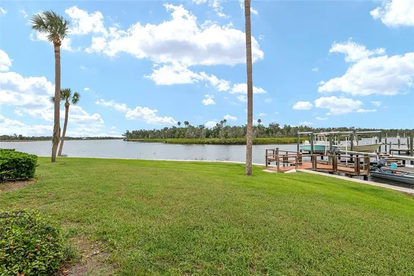 a view of a lake with houses in the back
