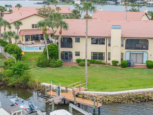 an aerial view of a house with swimming pool and patio