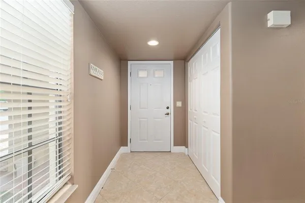 a view of a hallway with wooden floor and a bathroom