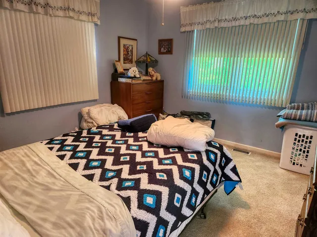 a bedroom with furniture and a window