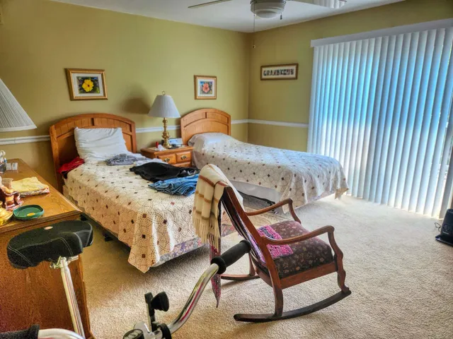 a bedroom with two beds and painting on the wall