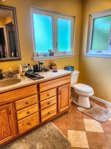 a bathroom with a toilet a sink and a mirror