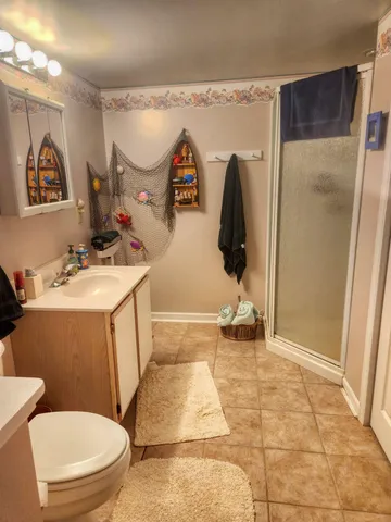 a bathroom with a sink toilet and shower