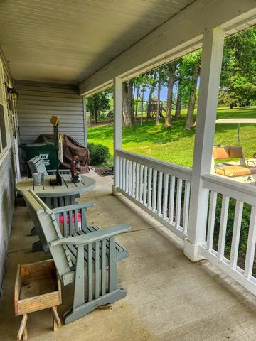 a view of deck with furniture and garden