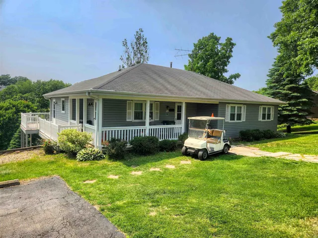 a front view of a house with a yard table and chairs