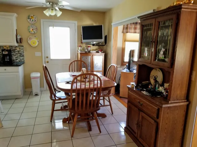 a dining room with furniture and window