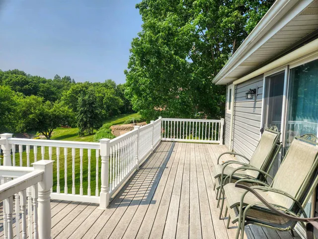 a view of balcony with wooden floor and outdoor seating