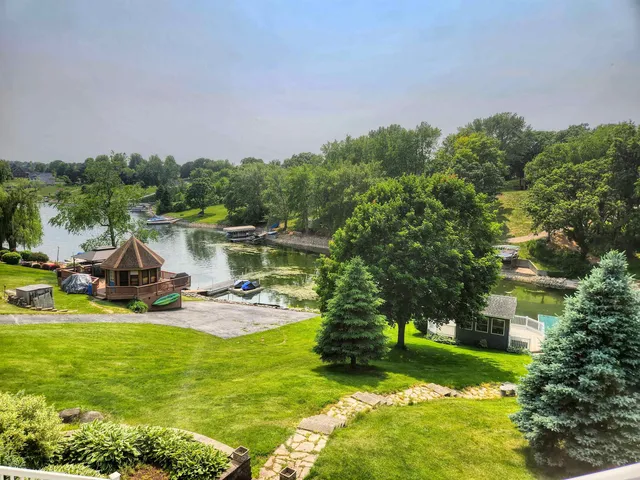 a view of a house with a yard and sitting area