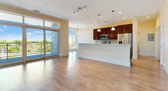 a large room with a chandelier and wooden floor