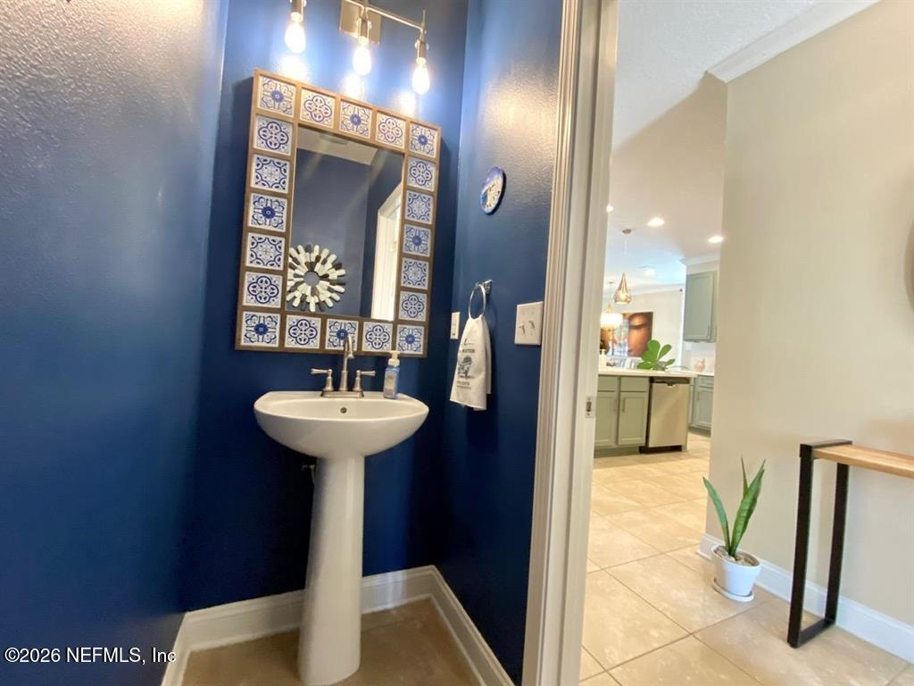 115 Sierras Loop St. Augustine, FL 32086 - Photo 23 of 65 a bathroom with a sink a mirror and a toilet