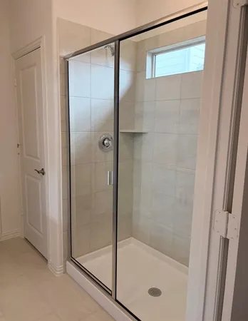 a bathroom with a glass shower door