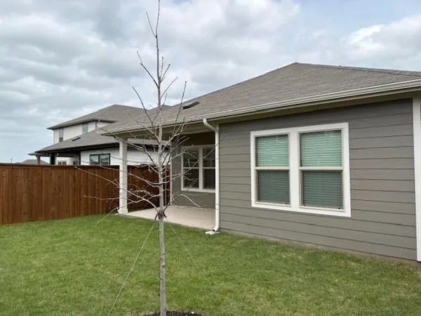 a view of a house with a backyard