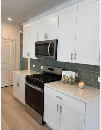 a kitchen with granite countertop cabinets and steel stainless steel appliances