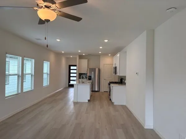 a view of a kitchen with a refrigerator and a window