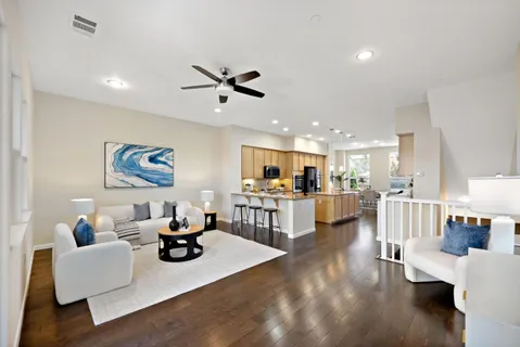 a living room with furniture and view of kitchen