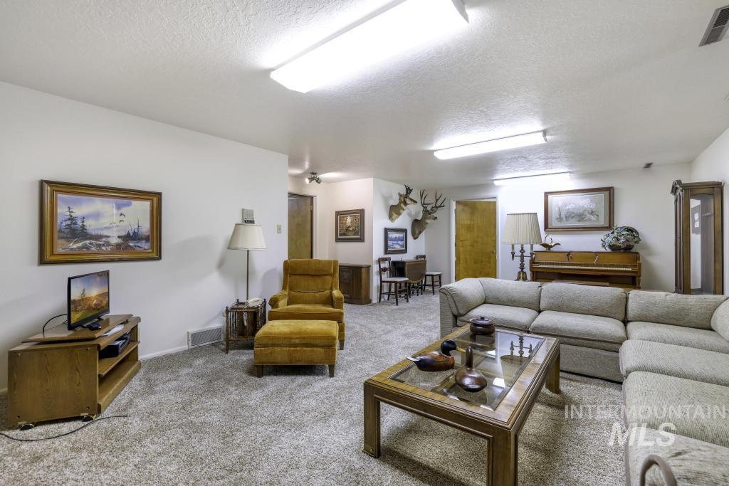 2018 Rancho Vista Drive Twin Falls, ID 83301 - Photo 40 of 50 Expansive living area with neutral carpeting and white painted walls