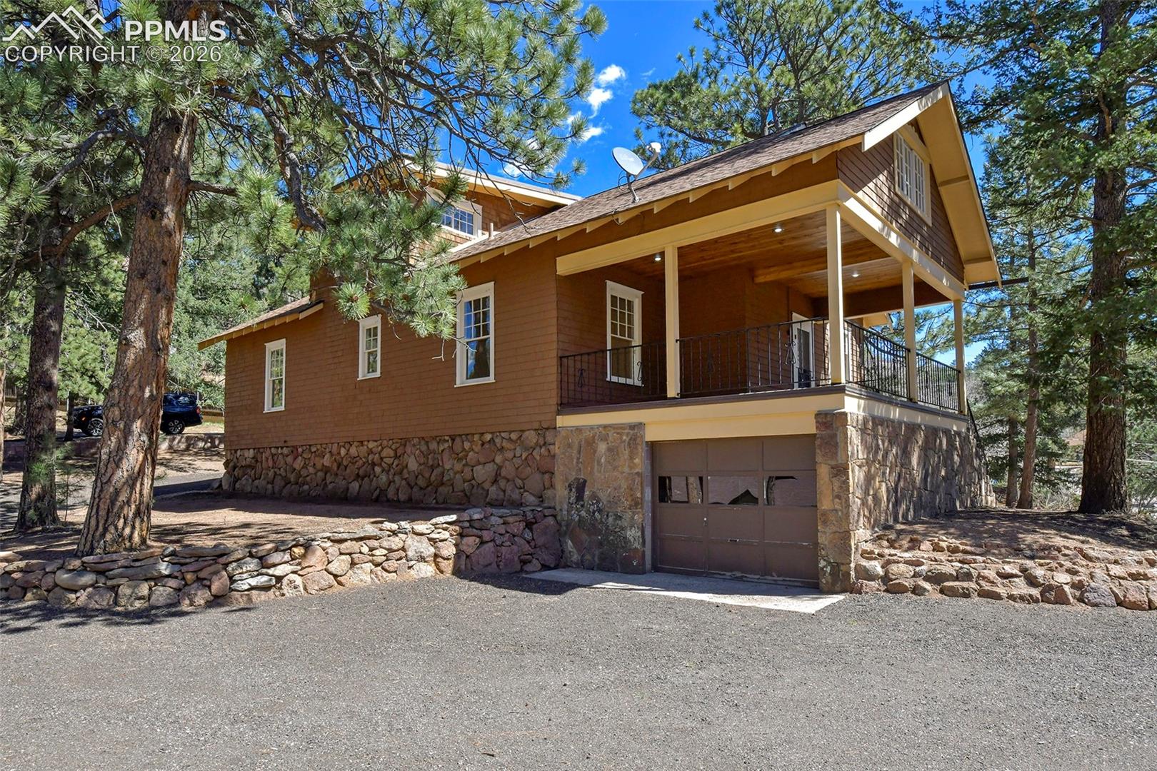 4530 Hagerman Road Cascade, CO 80809 - Photo 43 of 47 Back Of Home Showing The Large Deck And The Attached Garage