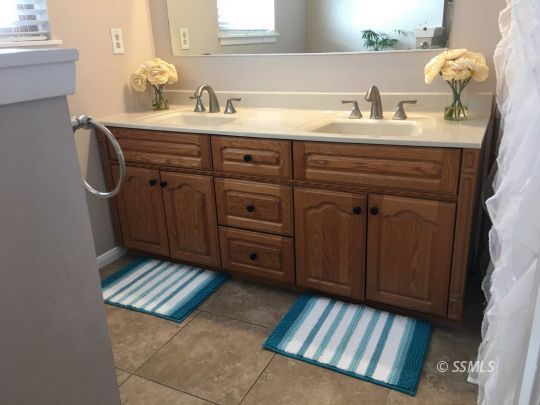 217 Rancho Street Ridgecrest, CA 93555 - Photo 13 of 25 a bathroom with a sink and a mirror