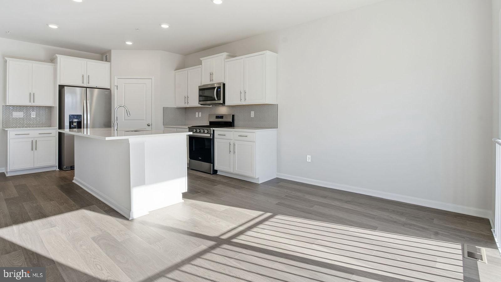 8110 Cypress Pt Drive Rosedale, MD 21237 - Photo 5 of 37 a kitchen with white cabinets and stainless steel appliances