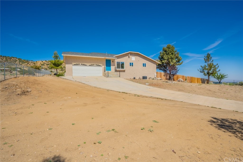 8268 Green Road Pinon Hills, CA 92372 - Photo 1 of 1 a front view of a house with a yard