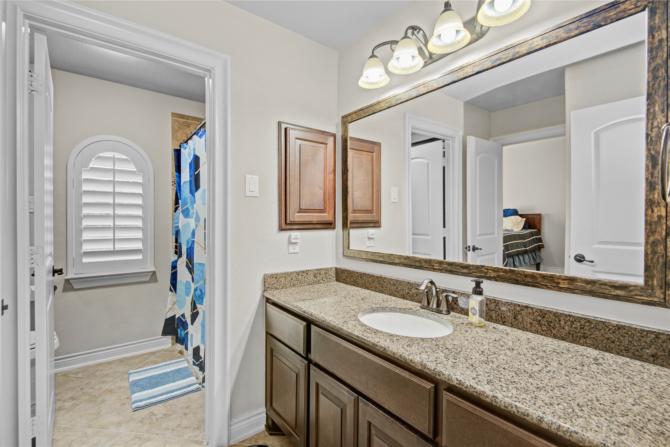 4315 Sanctuary Halls Spring, TX 77388 - Photo 27 of 50 a bathroom with a granite countertop sink and a mirror