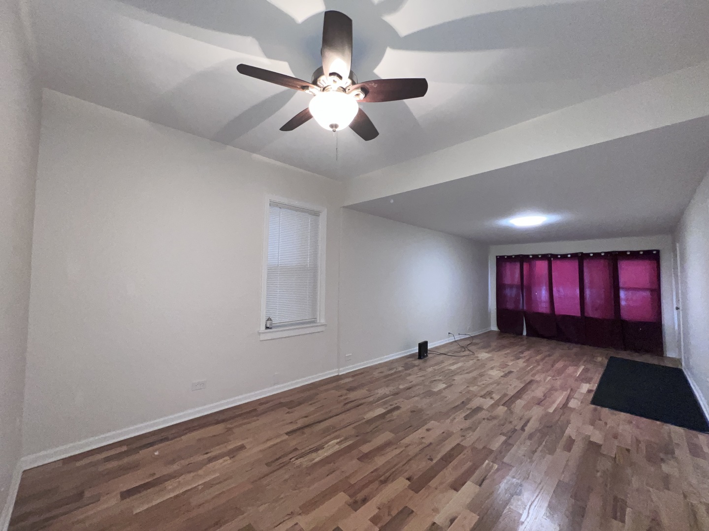 8919 South Muskegon Avenue, Unit 1F Chicago, IL 60617 - Photo 2 of 33 a view of a room with window ceiling fan and hardwood floor
