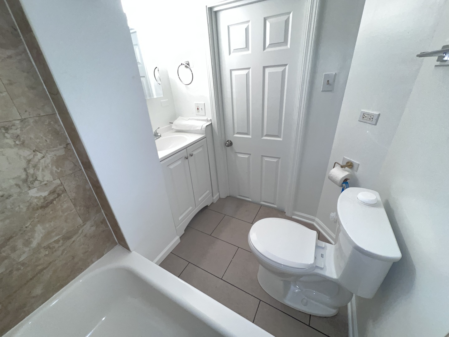 8919 South Muskegon Avenue, Unit 1F Chicago, IL 60617 - Photo 24 of 33 a bathroom with a sink a toilet and a mirror