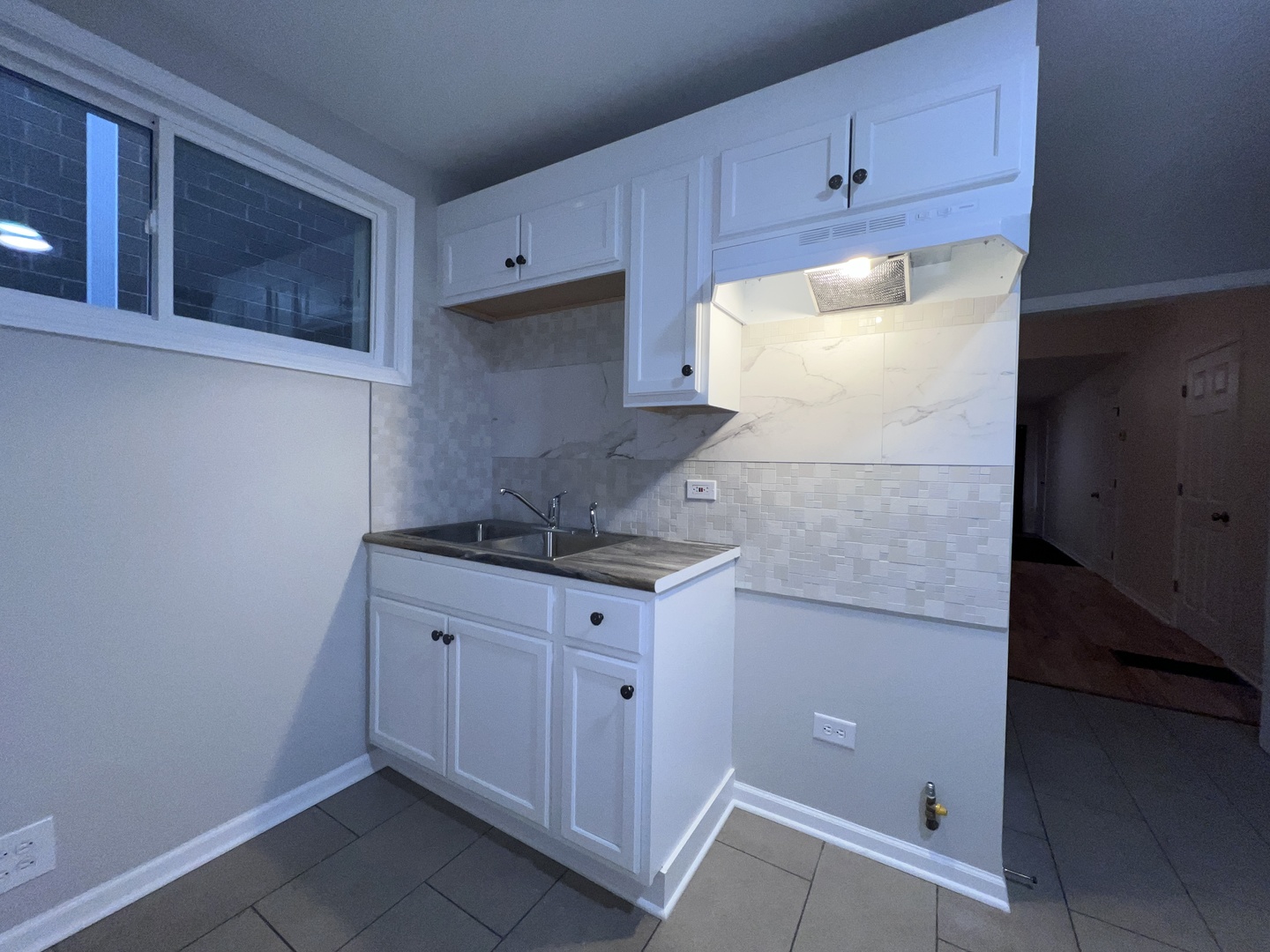 8919 South Muskegon Avenue, Unit 1F Chicago, IL 60617 - Photo 30 of 33 a kitchen with granite countertop white cabinets and white appliances