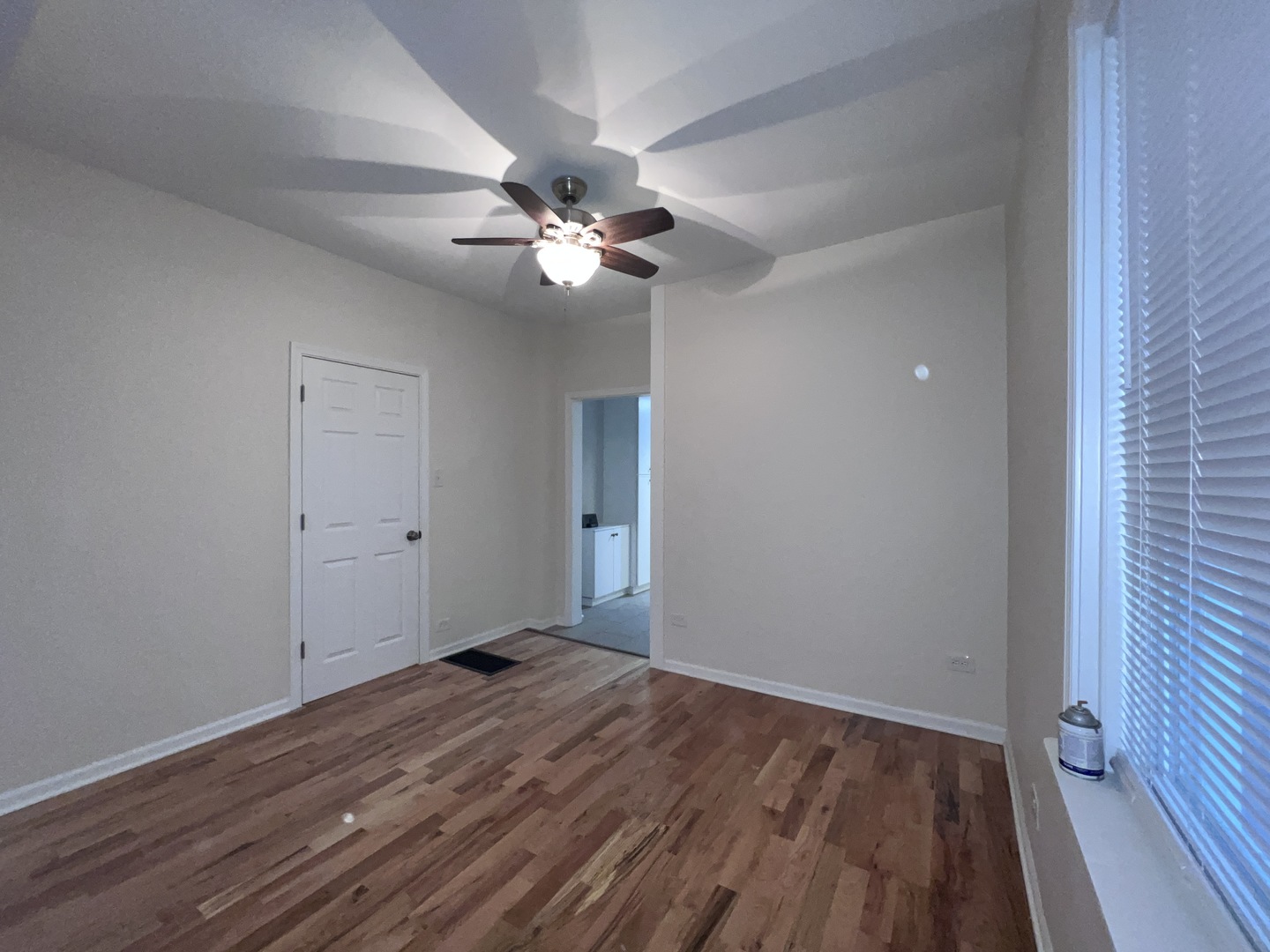8919 South Muskegon Avenue, Unit 1F Chicago, IL 60617 - Photo 5 of 33 wooden floor in an empty room with a window