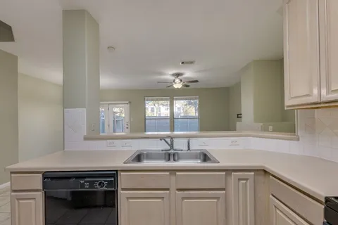 a kitchen with a sink and cabinets