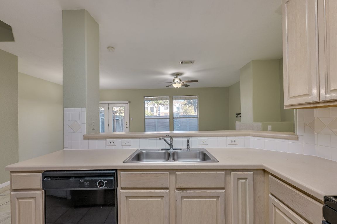 2100 Pipers Field Drive, Unit 14 Austin, TX 78758 - Photo 14 of 30 a kitchen with a sink and cabinets