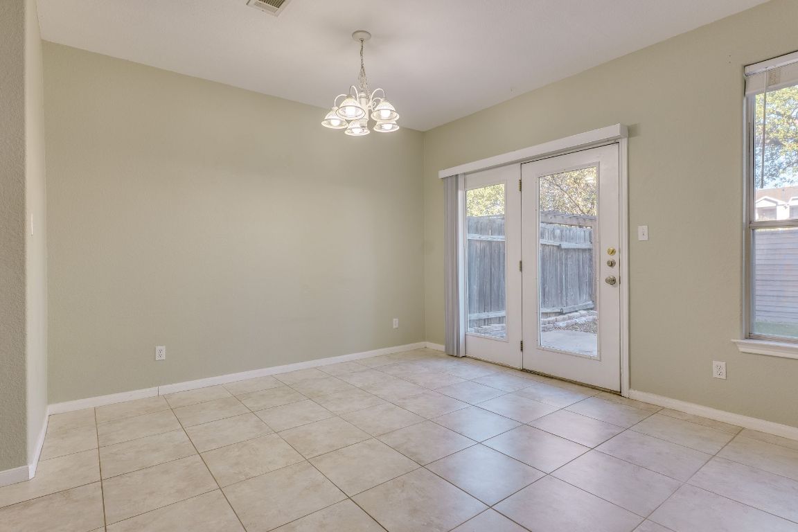 2100 Pipers Field Drive, Unit 14 Austin, TX 78758 - Photo 15 of 30 a view of an empty room with window and chandelier