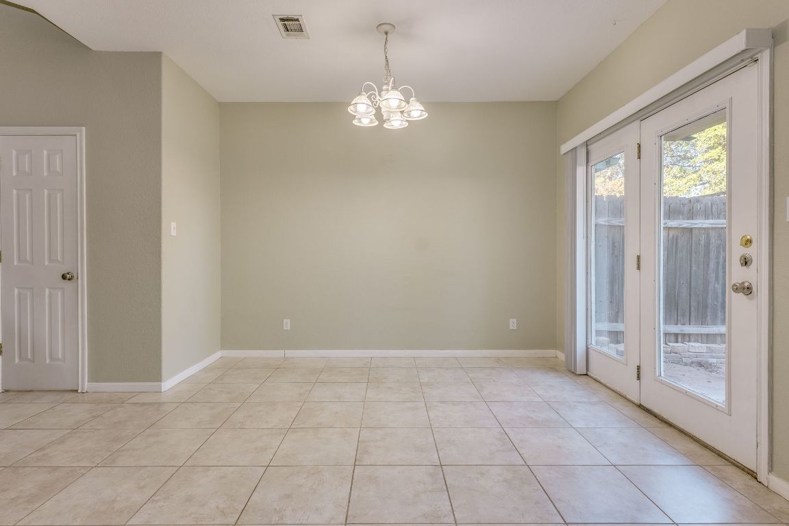 2100 Pipers Field Drive, Unit 14 Austin, TX 78758 - Photo 17 of 30 a view of an empty room with window and chandelier
