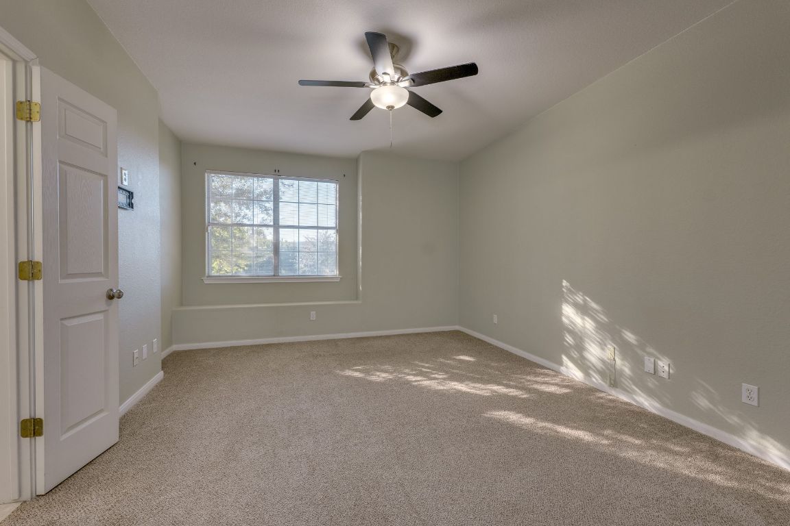 2100 Pipers Field Drive, Unit 14 Austin, TX 78758 - Photo 18 of 30 a view of a livingroom with a ceiling fan and window