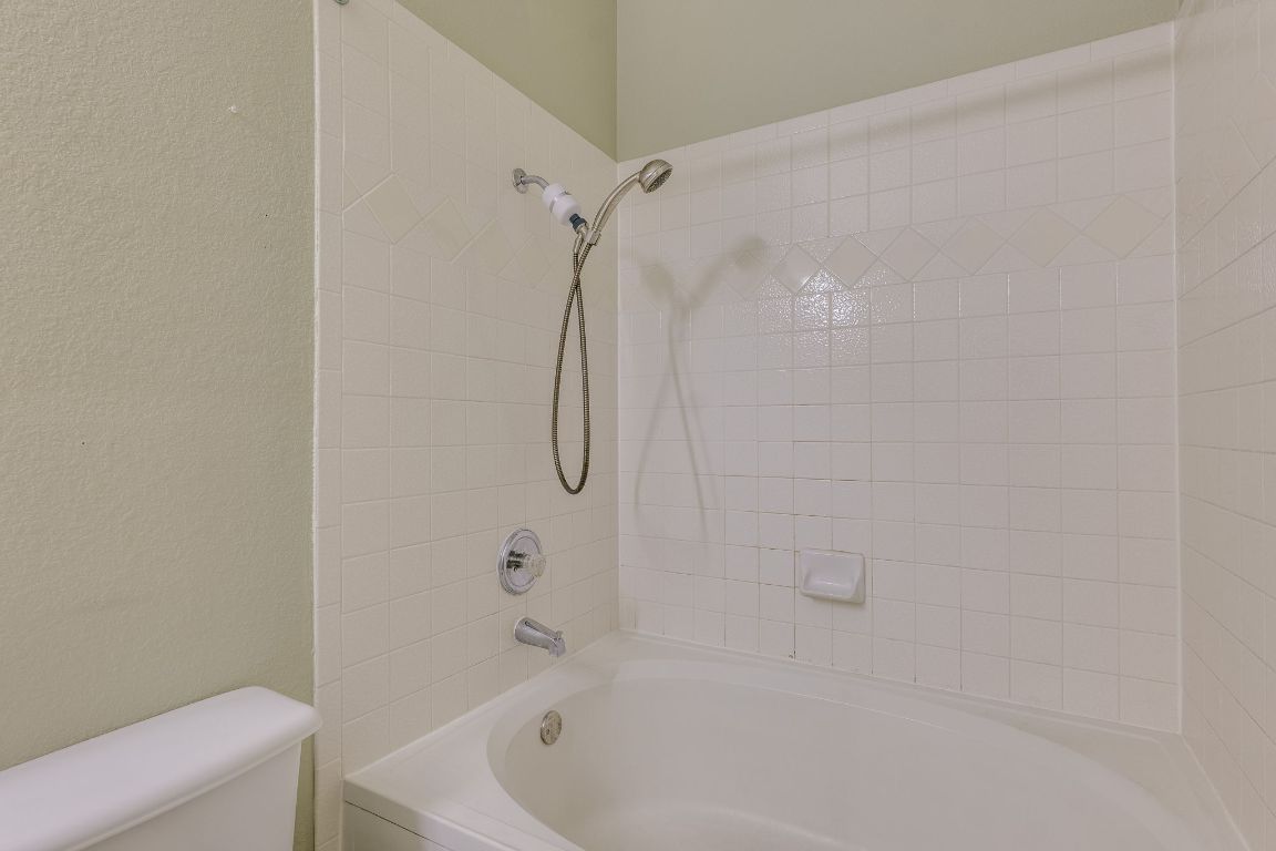 2100 Pipers Field Drive, Unit 14 Austin, TX 78758 - Photo 22 of 30 a bathroom with a bathtub and a shower