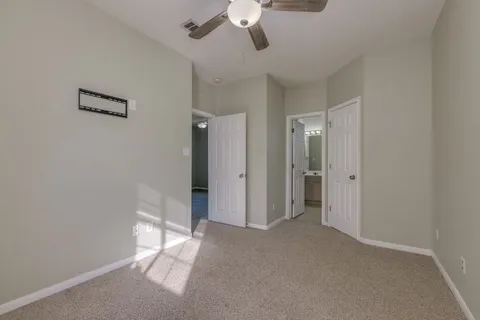 a view of empty room with a ceiling fan