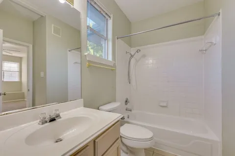 a bathroom with a sink mirror bathtub and toilet