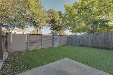 a view of a backyard with tree