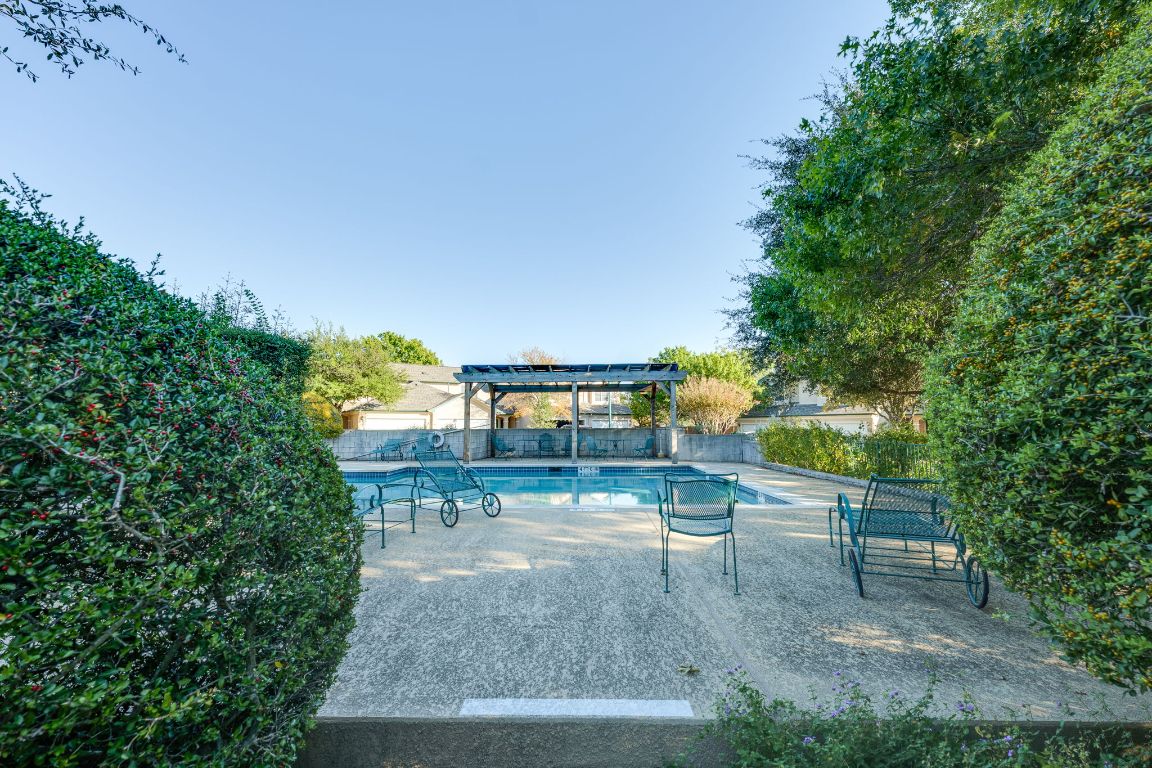 2100 Pipers Field Drive, Unit 14 Austin, TX 78758 - Photo 6 of 30 a view of a yard with plants and a bench