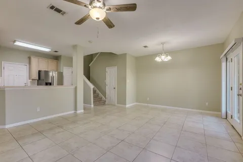 a view of a livingroom with a ceiling fan and window