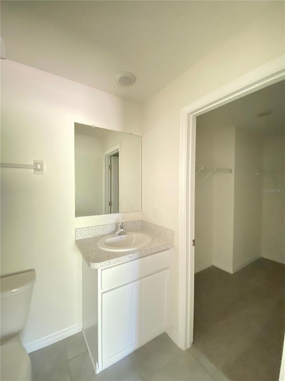 492 Hickory Course Loop Ocala, FL 34472 - Photo 21 of 28 a bathroom with a sink a toilet and a mirror