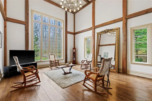 a living room filled with furniture and floor to ceiling windows