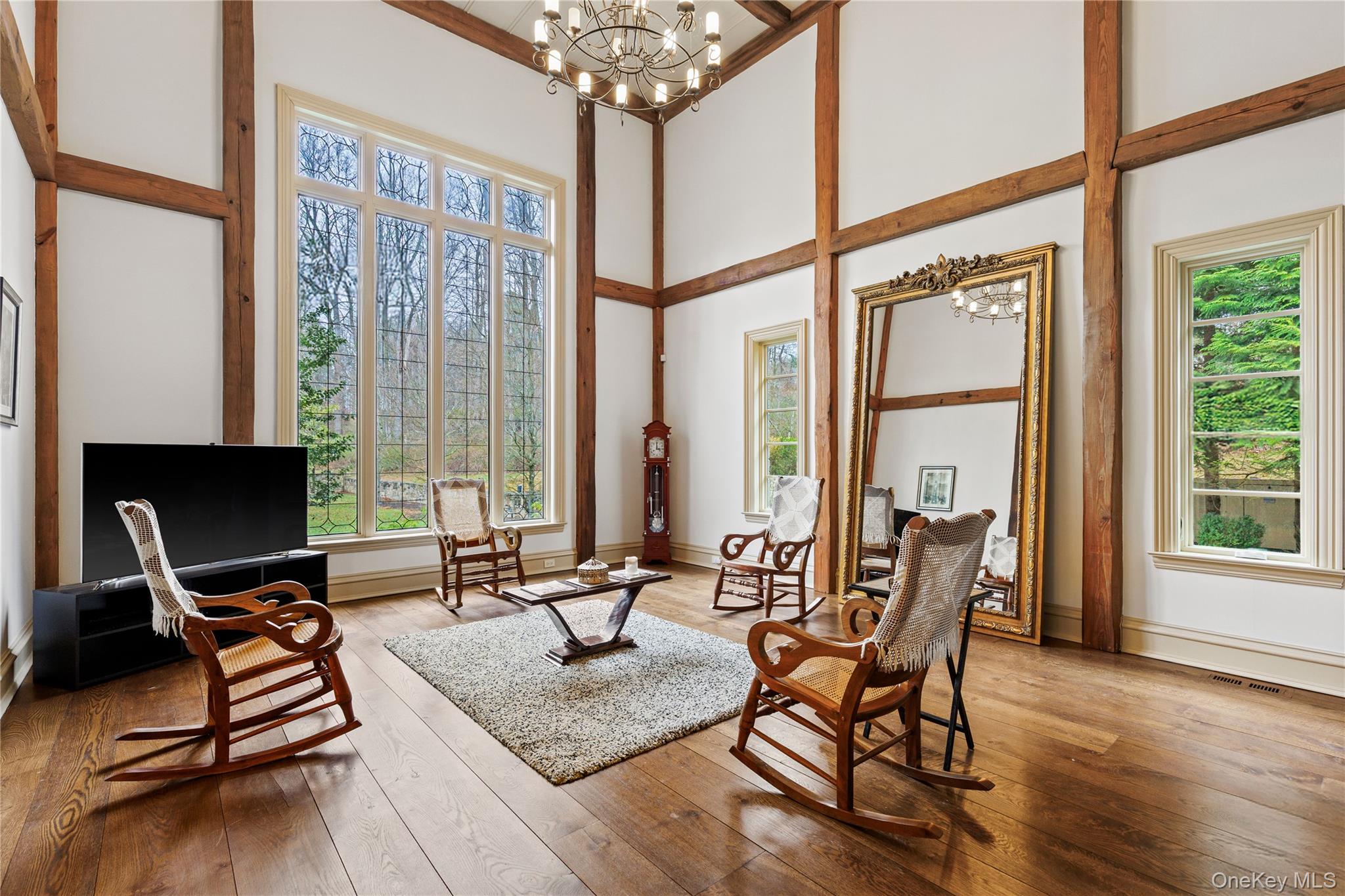 72 Guard Hill Road Bedford Corners, NY 10549 - Photo 13 of 50 a living room filled with furniture and floor to ceiling windows