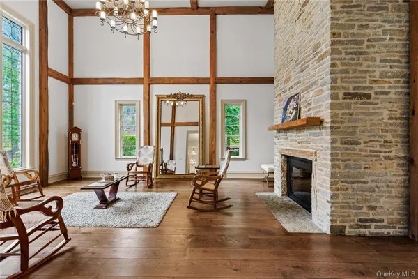 a living room with fireplace furniture and a large window
